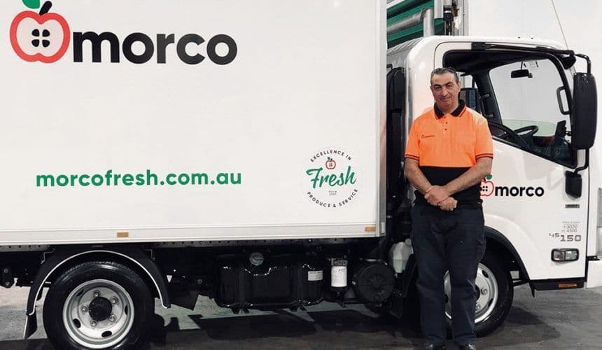 Morco driver standing by his truck