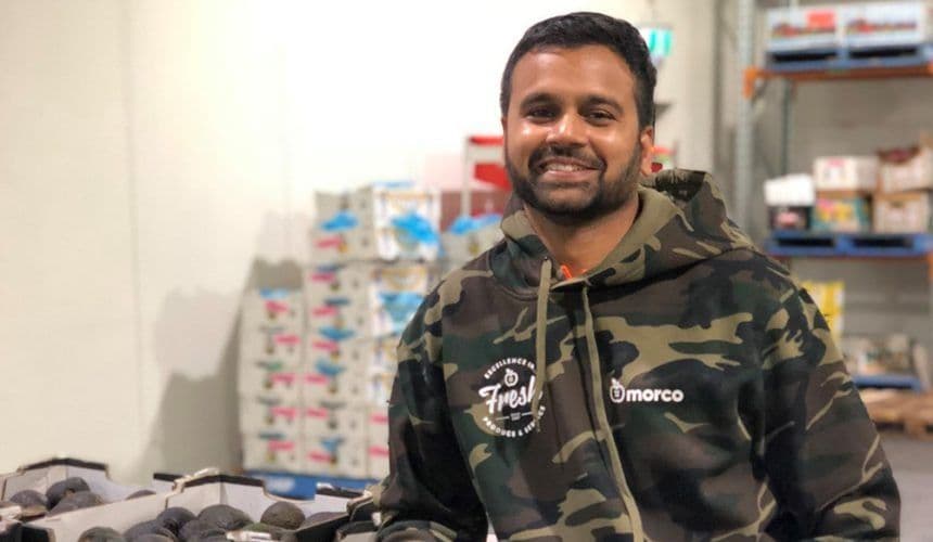 Ronnie standing in front of produce