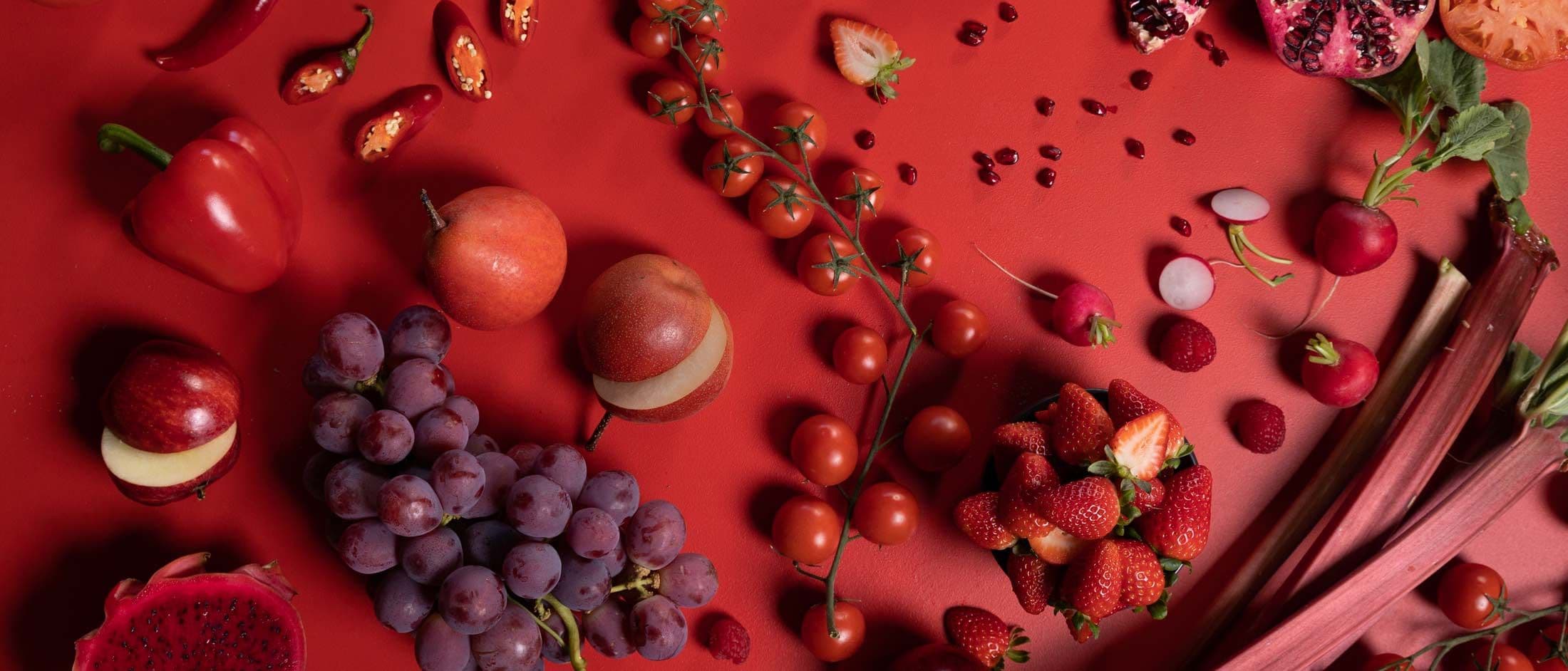 Red fruit and vegetables on a red table